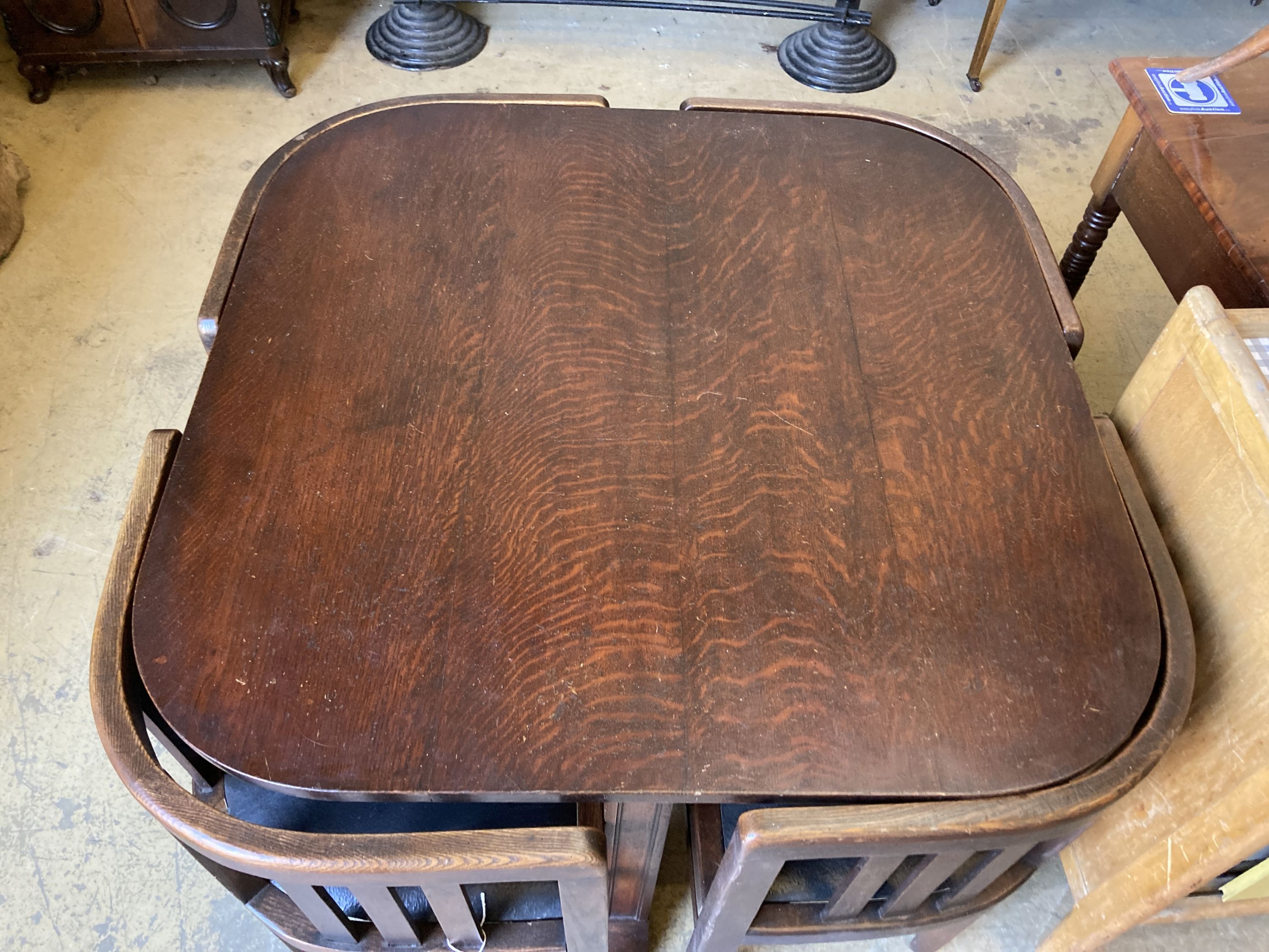 A Heals style oak table, length 92cm, depth 92cm, height 74cm and four chairs